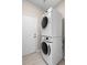 Modern laundry room features white stacked washer and dryer at 1112 Jasmine Creek Ct, Sun City Center, FL 33573