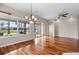 Bright living room with hardwood floors, chandelier, ceiling fan and sliding doors to the patio at 1112 Jasmine Creek Ct, Sun City Center, FL 33573