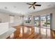 Open concept living room with hardwood floors, fan, and dining area at 1112 Jasmine Creek Ct, Sun City Center, FL 33573