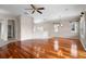 Open concept living room with hardwood floors, fan, and kitchen with stainless steel appliances at 1112 Jasmine Creek Ct, Sun City Center, FL 33573