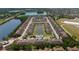 Aerial view of a townhome community featuring a lake, pool and manicured landscaping at 11442 Crowned Sparrow Ln, Tampa, FL 33626