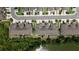 Aerial view showcases townhomes near water with lush greenery and neatly manicured lawns at 11442 Crowned Sparrow Ln, Tampa, FL 33626