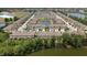 An aerial view of a well-maintained townhouse community, showcasing landscaping and water views at 11442 Crowned Sparrow Ln, Tampa, FL 33626