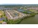 Aerial view of townhome community with lake, landscaping, and community pool at 11442 Crowned Sparrow Ln, Tampa, FL 33626