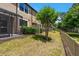 Backyard of home showcasing mature landscaping, and enclosed patio at 11442 Crowned Sparrow Ln, Tampa, FL 33626