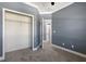 Bedroom with an open closet space and blue walls, offering ample storage at 11442 Crowned Sparrow Ln, Tampa, FL 33626