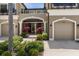 Charming entrance with a covered porch and a well-maintained front garden with colorful plants at 11442 Crowned Sparrow Ln, Tampa, FL 33626
