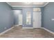 Inviting entryway with tile floors, white trim, and a sidelight window above the front door at 11442 Crowned Sparrow Ln, Tampa, FL 33626