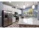 Modern kitchen with stainless steel appliances, granite counters, and white cabinets at 11442 Crowned Sparrow Ln, Tampa, FL 33626