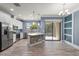 Beautiful kitchen with an island, stainless appliances, and an adjacent living area at 11442 Crowned Sparrow Ln, Tampa, FL 33626