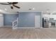Open-concept living room with tile flooring, custom wall paneling, and kitchen views at 11442 Crowned Sparrow Ln, Tampa, FL 33626