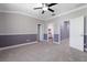 Spacious bedroom with soft carpet, crown molding, and an ensuite bathroom at 11442 Crowned Sparrow Ln, Tampa, FL 33626