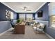 Modern home office with ample natural light, desk, seating, and contemporary decor at 11442 Crowned Sparrow Ln, Tampa, FL 33626