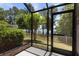 Screened patio with views of a lake and lush landscaping at 11442 Crowned Sparrow Ln, Tampa, FL 33626