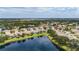 An aerial view highlights the community's homes nestled around a scenic lake, showcasing the lush surroundings at 11457 Captiva Kay Dr, Riverview, FL 33569
