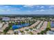 Beautiful aerial view shows the community with homes surrounding a lake, conveniently near shopping areas and lush greenery at 11457 Captiva Kay Dr, Riverview, FL 33569