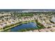 Expansive aerial view showcasing the community's layout with numerous homes surrounding a beautiful, large lake at 11457 Captiva Kay Dr, Riverview, FL 33569