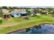 Aerial view of property with a lush lawn, lake view and screened in patio at 11457 Captiva Kay Dr, Riverview, FL 33569