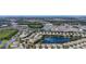 Extensive aerial view displaying the community, featuring homes, lakes, shopping centers, and beautiful surrounding foliage at 11457 Captiva Kay Dr, Riverview, FL 33569