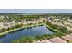 An aerial view shows the serene community, with homes lining the picturesque lake, creating a peaceful neighborhood at 11457 Captiva Kay Dr, Riverview, FL 33569