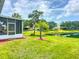 Manicured lawn leading to tranquil water feature, complemented by mature trees at 11457 Captiva Kay Dr, Riverview, FL 33569