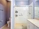 Bathroom featuring walk-in shower with glass enclosure and convenient accessibility hand rail at 11457 Captiva Kay Dr, Riverview, FL 33569