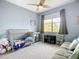 Serene Bedroom featuring a crib, comfortable sofa, ample natural light, and neutral tones for a calming atmosphere at 11457 Captiva Kay Dr, Riverview, FL 33569