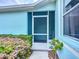 Inviting screened front door with a Welcome sign, surrounded by mature landscaping and a bright exterior at 11457 Captiva Kay Dr, Riverview, FL 33569