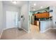 Open-concept kitchen and entryway featuring a breakfast bar, stainless steel appliances, and tile flooring at 11457 Captiva Kay Dr, Riverview, FL 33569