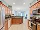 Open kitchen with stainless steel refrigerator overlooks the spacious living area at 11457 Captiva Kay Dr, Riverview, FL 33569