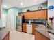 The modern kitchen features stainless steel appliances, ample cabinet space, and tile flooring at 11457 Captiva Kay Dr, Riverview, FL 33569