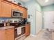 Well-equipped kitchen features stainless steel appliances and wood cabinets at 11457 Captiva Kay Dr, Riverview, FL 33569