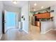 Open-concept kitchen and entryway featuring a breakfast bar, stainless steel appliances, and tile flooring at 11457 Captiva Kay Dr, Riverview, FL 33569