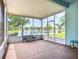 Screened lanai overlooking lake with a table and chair set for enjoying the view at 11457 Captiva Kay Dr, Riverview, FL 33569