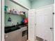 Laundry room showcasing newer washer and dryer set, with shelving for organized storage at 11457 Captiva Kay Dr, Riverview, FL 33569