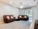 The inviting living room features a ceiling fan, tile floors, and comfortable couches at 11457 Captiva Kay Dr, Riverview, FL 33569