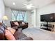 Relax in the inviting living room featuring tile floors and access to outdoor spaces at 11457 Captiva Kay Dr, Riverview, FL 33569