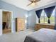 Spacious bedroom featuring a ceiling fan, dresser, large window, and convenient access to the nearby common areas at 11457 Captiva Kay Dr, Riverview, FL 33569