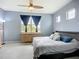 Cozy bedroom featuring a ceiling fan, ample windows, and a dresser for storage, creating a peaceful retreat at 11457 Captiva Kay Dr, Riverview, FL 33569