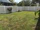 Spacious backyard featuring a well-maintained lawn and a tall wooden fence for privacy at 1165 Falcon Dr, Dunedin, FL 34698