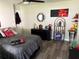 Comfortable bedroom with hardwood floors, a full-sized bed, dark wood furniture, and shelving at 1165 Falcon Dr, Dunedin, FL 34698