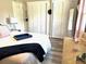 Bright bedroom featuring light-colored flooring, built-in closet, and natural light from the window at 1165 Falcon Dr, Dunedin, FL 34698