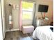 Stylish bedroom with light grey walls, modern furnishings, and a bright window view at 1165 Falcon Dr, Dunedin, FL 34698