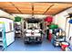 Organized garage featuring epoxy flooring, ample storage, and a convenient golf cart, maximizing space and functionality at 1165 Falcon Dr, Dunedin, FL 34698