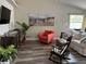 Cozy living room showcasing neutral walls, coastal artwork, and comfortable seating arrangement at 1165 Falcon Dr, Dunedin, FL 34698