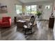 Inviting living room featuring wood floors, a comfortable sofa, and a decorative rocking chair at 1165 Falcon Dr, Dunedin, FL 34698