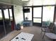 Relaxing screened patio featuring comfortable seating and a mounted television for entertainment at 1165 Falcon Dr, Dunedin, FL 34698