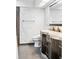 Well lit bathroom with granite counter tops and sleek black cabinets at 11783 Ashley Ct, Seminole, FL 33772