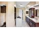 Bathroom offers granite countertops, dark wood cabinetry, and ample storage space at 11783 Ashley Ct, Seminole, FL 33772