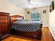 Cozy bedroom features hardwood floors, a ceiling fan, and natural light at 11783 Ashley Ct, Seminole, FL 33772